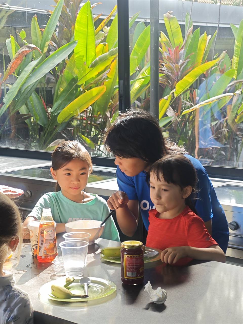 Holiday campers preparing snacks with a coach
