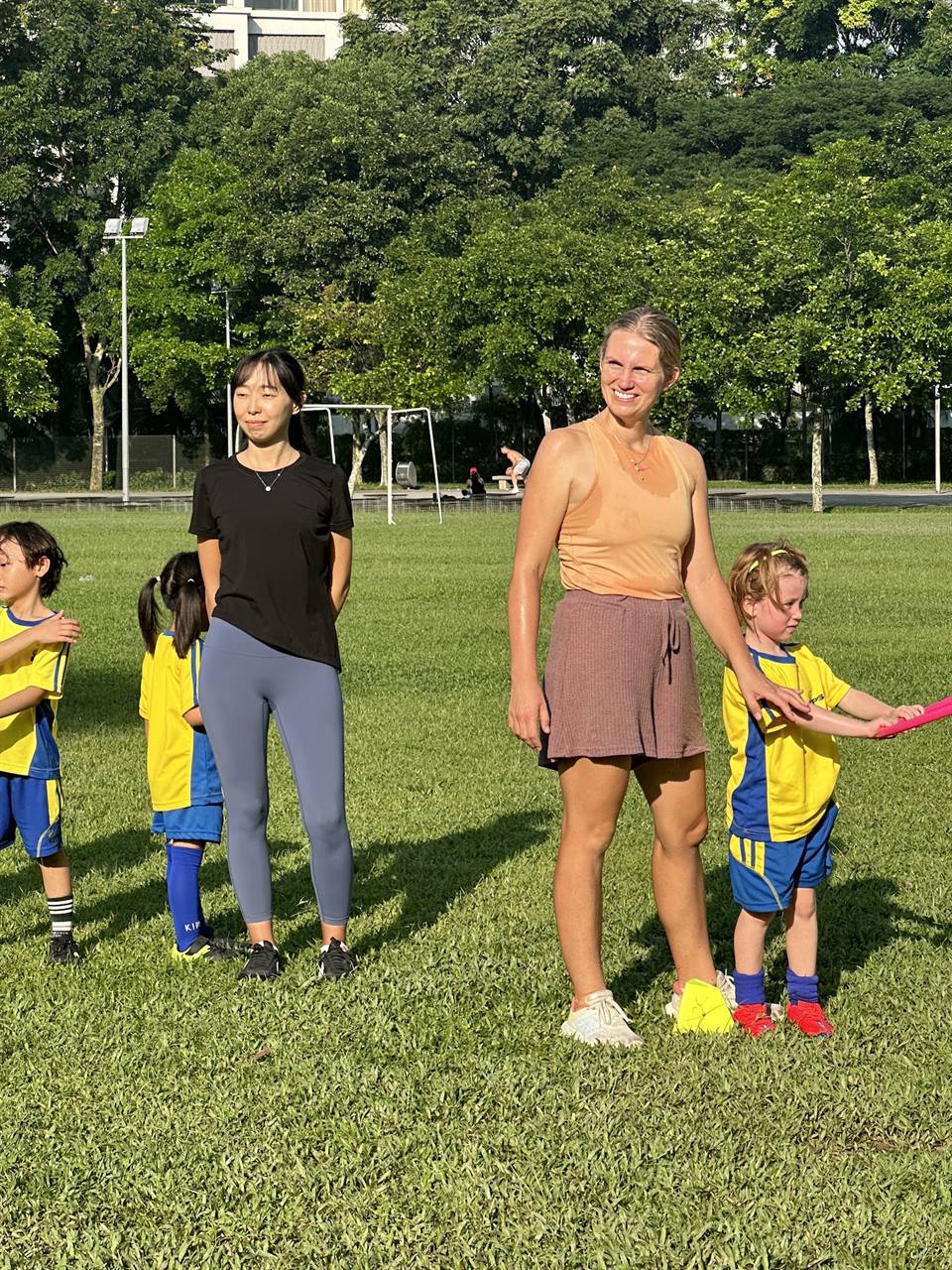Coaches running a football session with young children