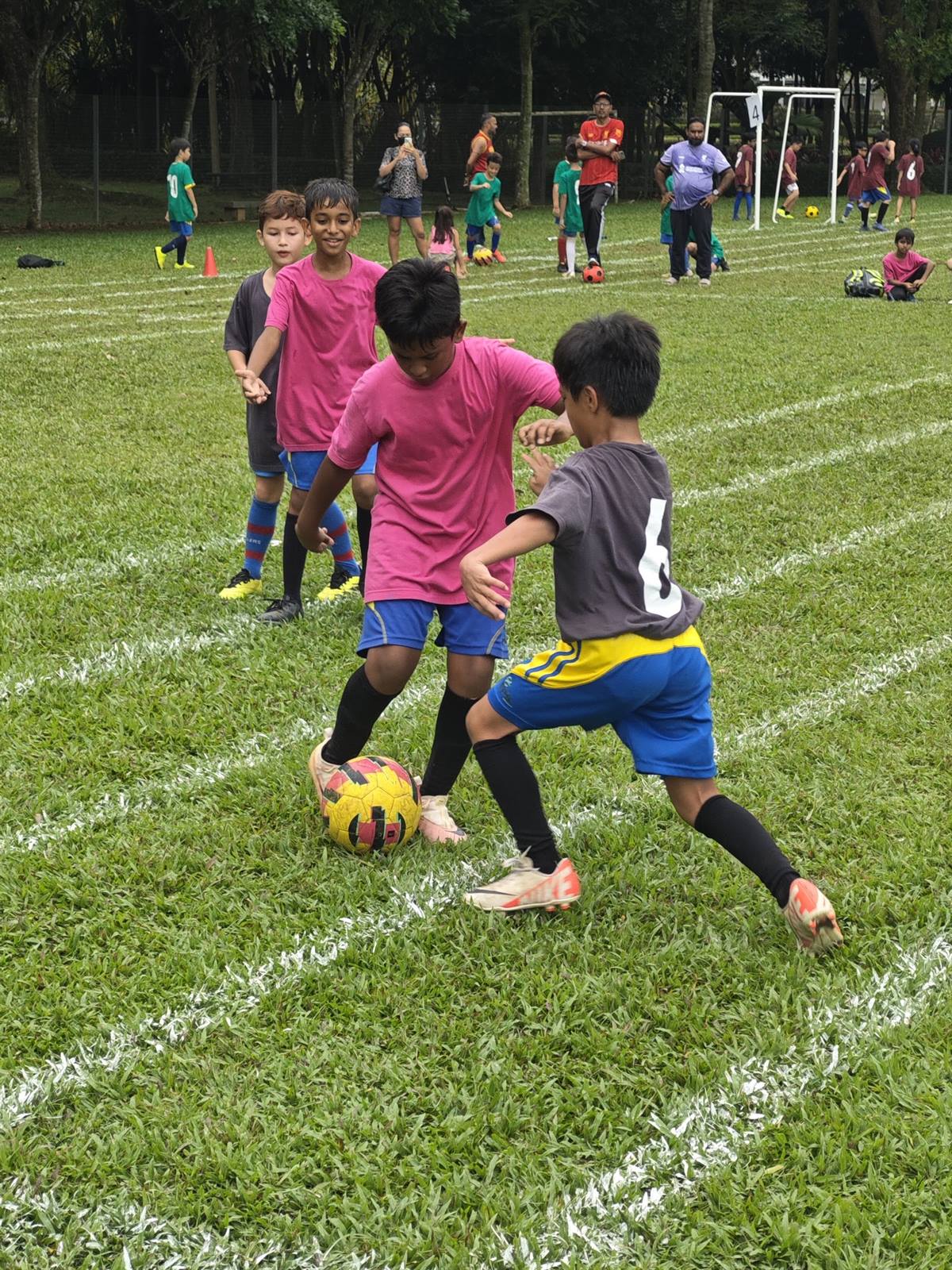 Two young players competing for the ball at the EPS Football Tournament