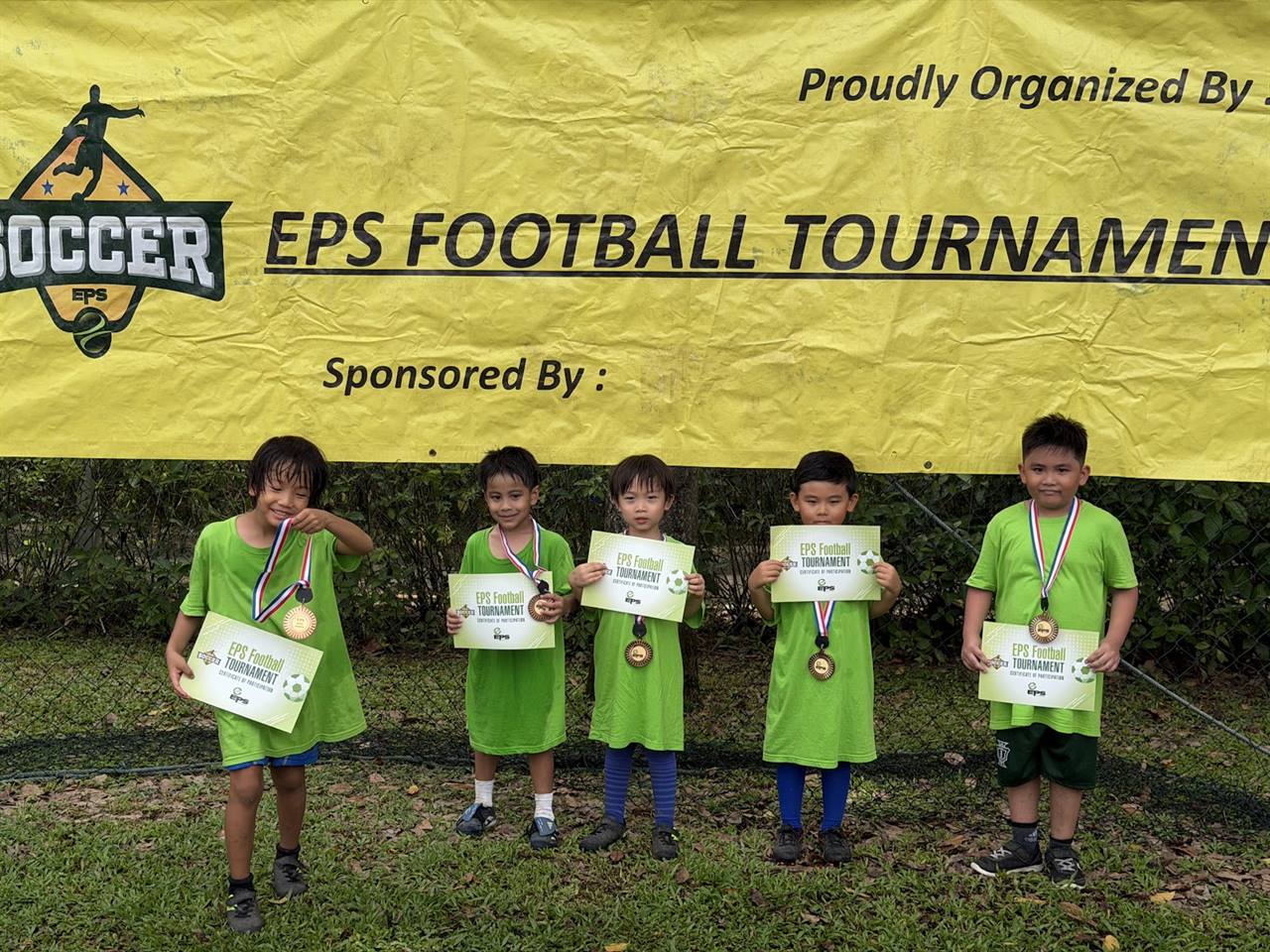 Young EPS players proudly holding their tournament certificates